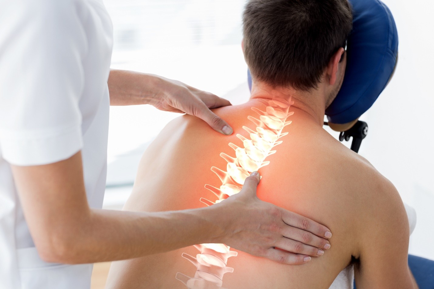 A person receiving a back adjustment with an overlay of the spine